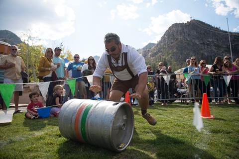 A man participates in a keg rolling contest at Oktoberfest. 