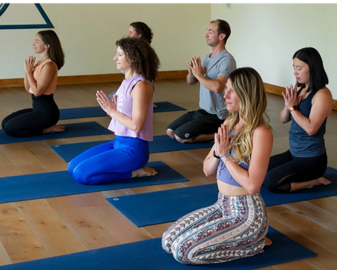 Yoga participants meditating at Palisades Tahoe