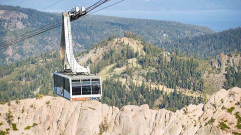 The Palisades Tahoe Aerial Tram on a Summer Day with Lake Tahoe in the background.