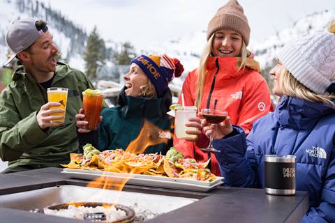 Happy customers eating and drinking at Palisades Tahoe.