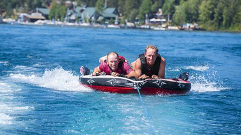 Jim and John Morrison tubing on Lake Tahoe.