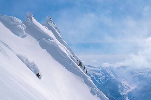 Elyse skis down mountain.