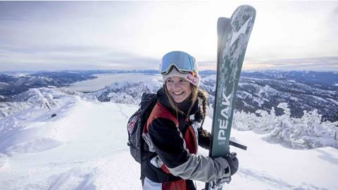 Michelle Parker holding skis. 