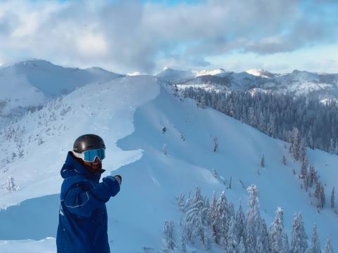 Skier pointing at deep terrain. 