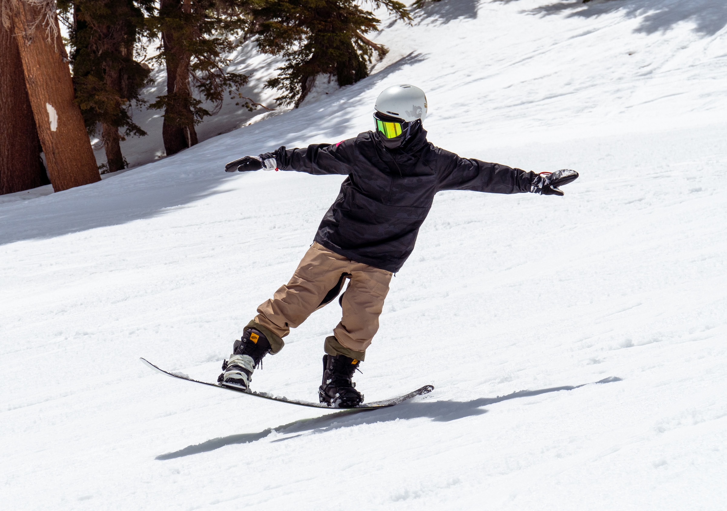 Snowboarder making butter on mountain.