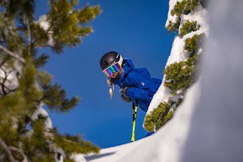 Telemark skier rides down mountain.