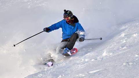 Skier races down run.