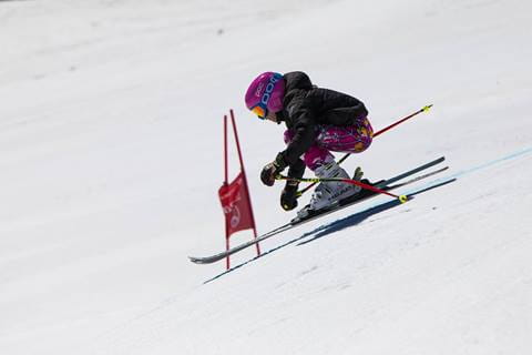 Ski racer races down mountain. 