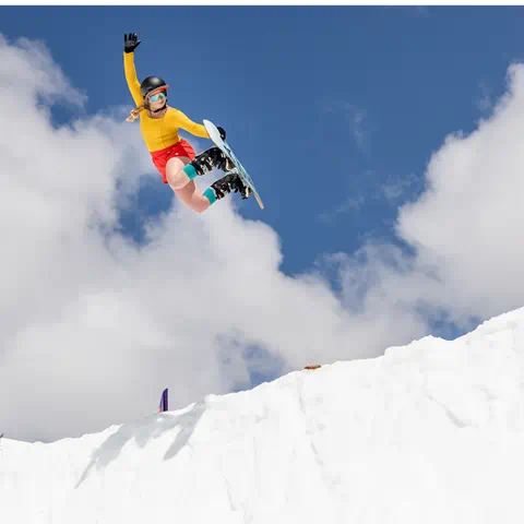 Snowboarder in bright colors takes a jump