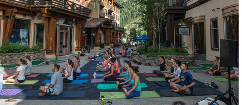 People doing yoga in The Village at Palisades Tahoe