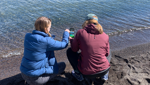 Two people checking water in Lake Tahoe