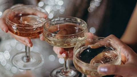 Three guests holding champagne glasses.