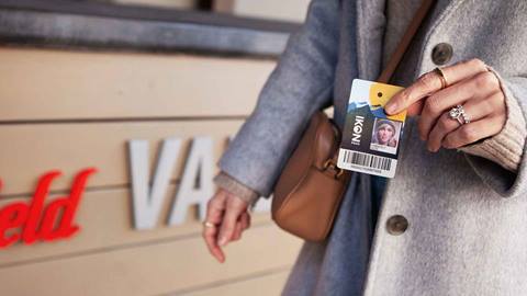 A woman showing her Ikon Pass at Westfield Valley mall. 