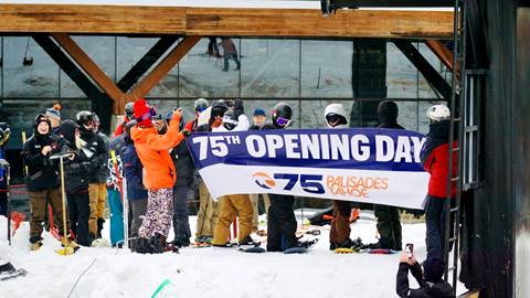 Skiers and riders breaking through banner on first chairlift of the 24-25 season. 