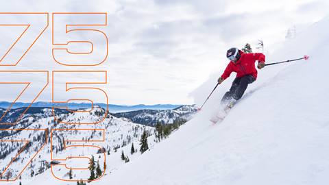 Skier turning through fresh powder snow at Palisades Tahoe