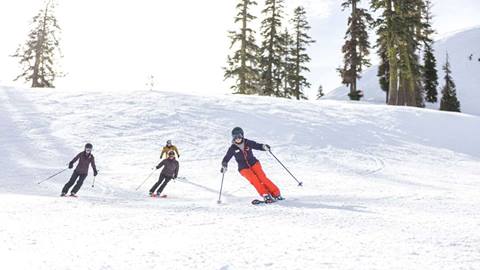 Women of Winter 3 Day Camp skis down a run at Palisades Tahoe. 