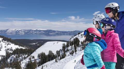 Family skis at High Camp overlooking Lake Tahoe.