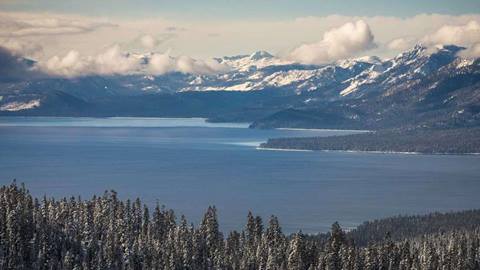 Scenic photography of Lake Tahoe with snow capped mountains in the Winter.