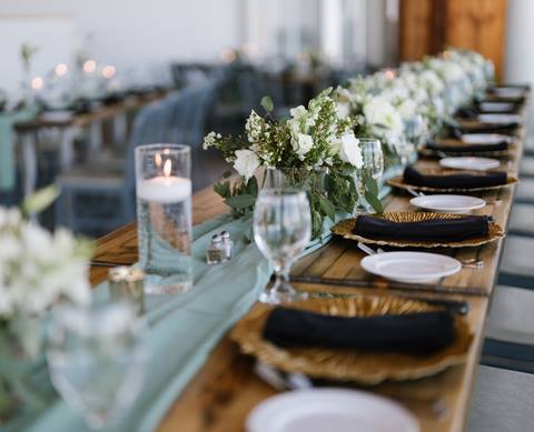 Neat arrangement of tableware at a chic wedding venue. 