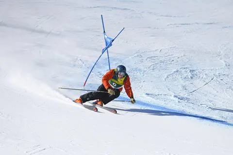 Skier going around a blue gate on a race course