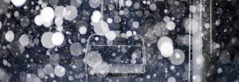 Snowfall at night in front of a chairlift at Alpine Meadows, California