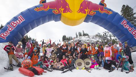 Group of skiers, snowboarders and ski bladers dressed in costume at the Pain McShlonkey event at Palisades Tahoe under the Red Bull banner