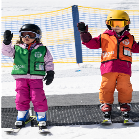 Two kids smiling on magic carpet