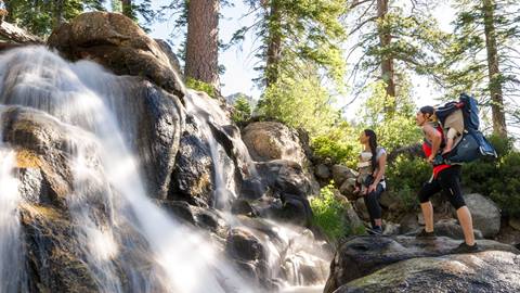 Two women and a baby hiking Shirley Canyon in Olympic Valley at Palisades Tahoe