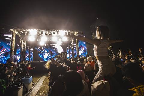 View of the stage from the crowd at a lively concert