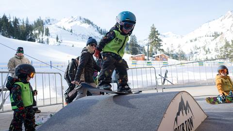 a boy playing on the carpet in the Burton Riglet Park at Squaw Valley